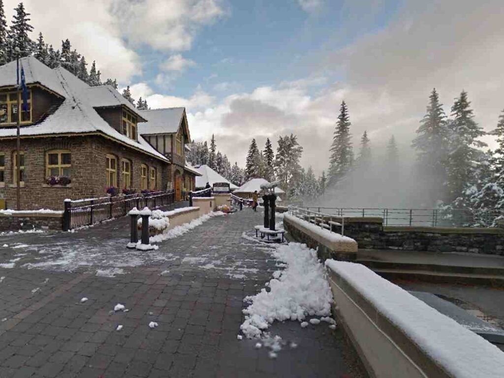 Snow falling around  pool during a quiet winter evening