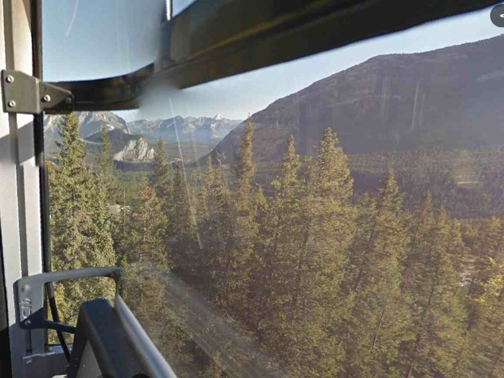 Tourists riding the Banff Gondola with Sulphur Mountain in the background